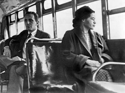 Rosa Parks, seated on the bus where her act of defiance became a symbol of resistance and change. Image from, “Rosa Parks” by Britannica https://www.britannica.com/biography/Rosa-Parks